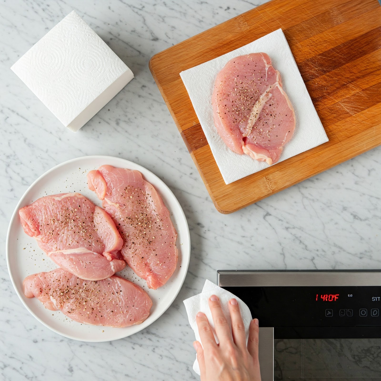 Raw turkey cutlets seasoned with black pepper and salt
