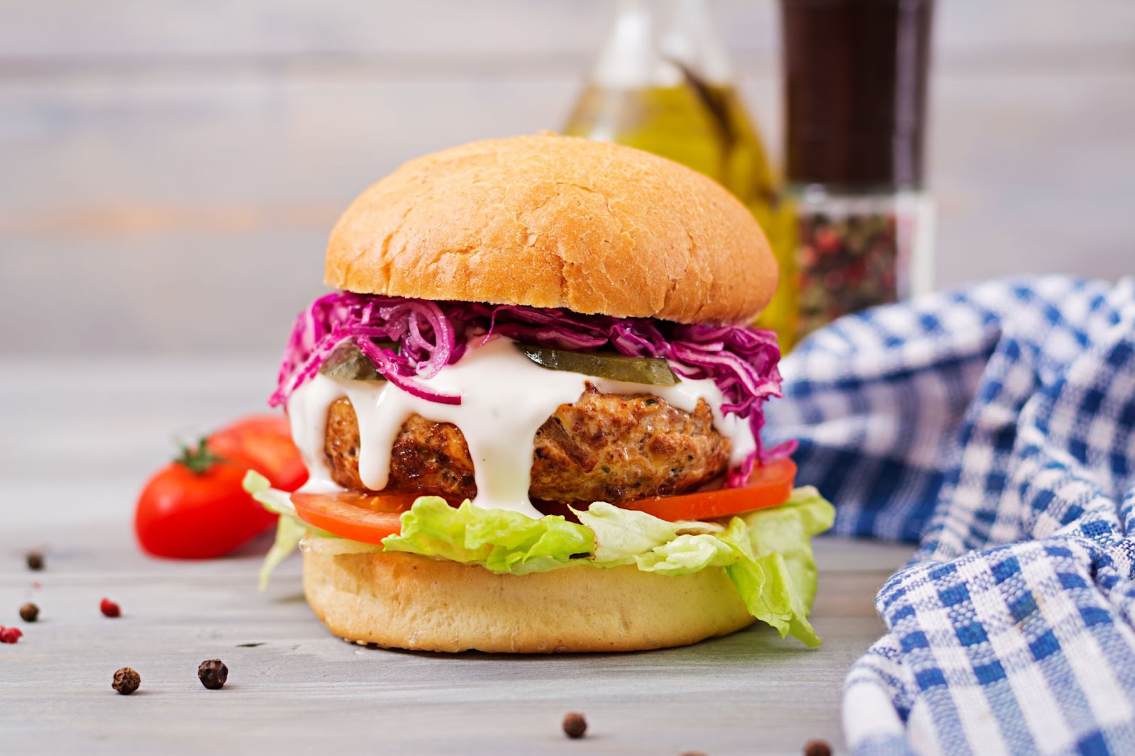 assembled spicy chicken cutlet sandwich with dripping sauce ready to be served