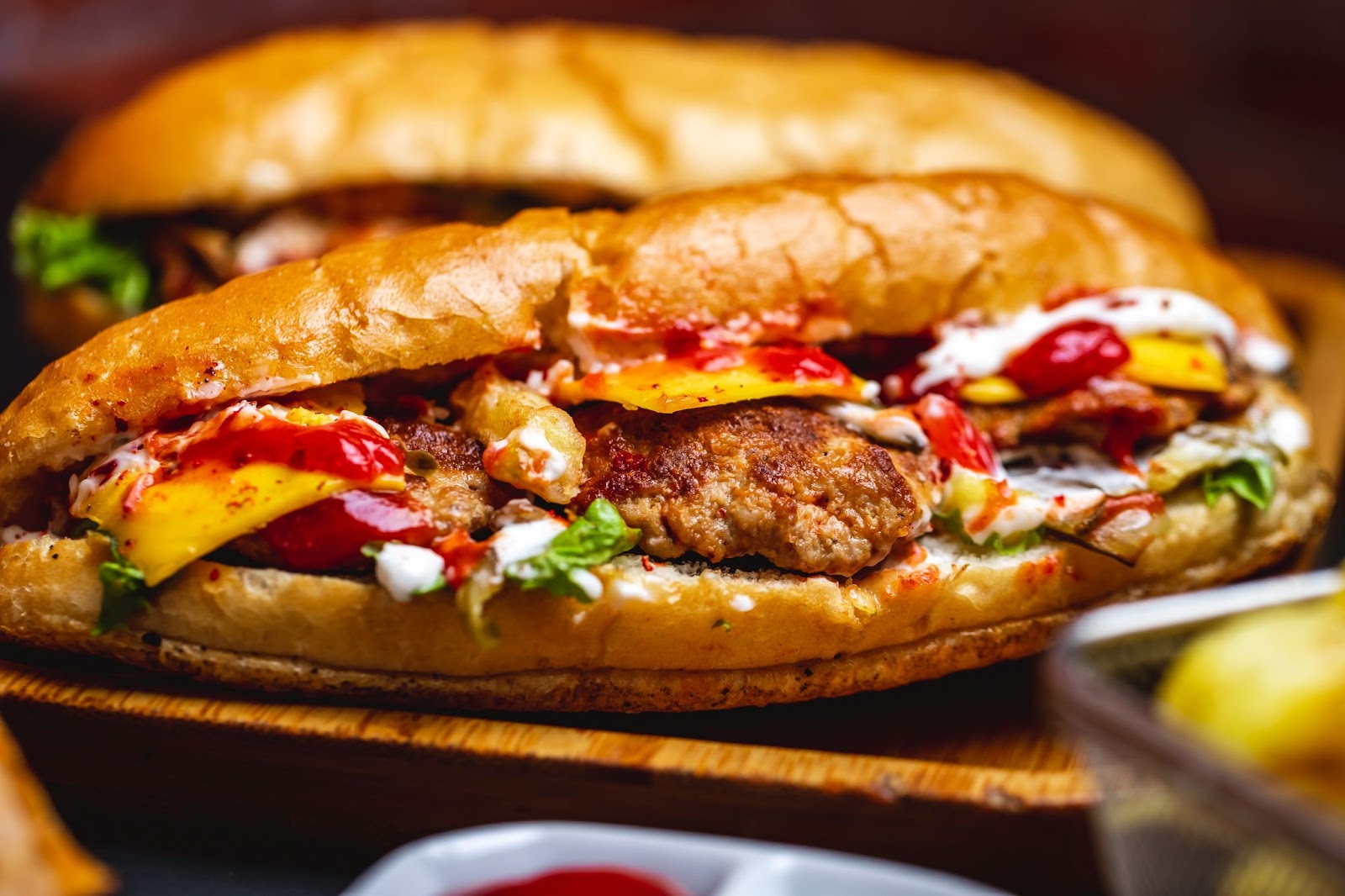 Sub Roll sandwich filled with cutlets, salad, sauce and cheese slice