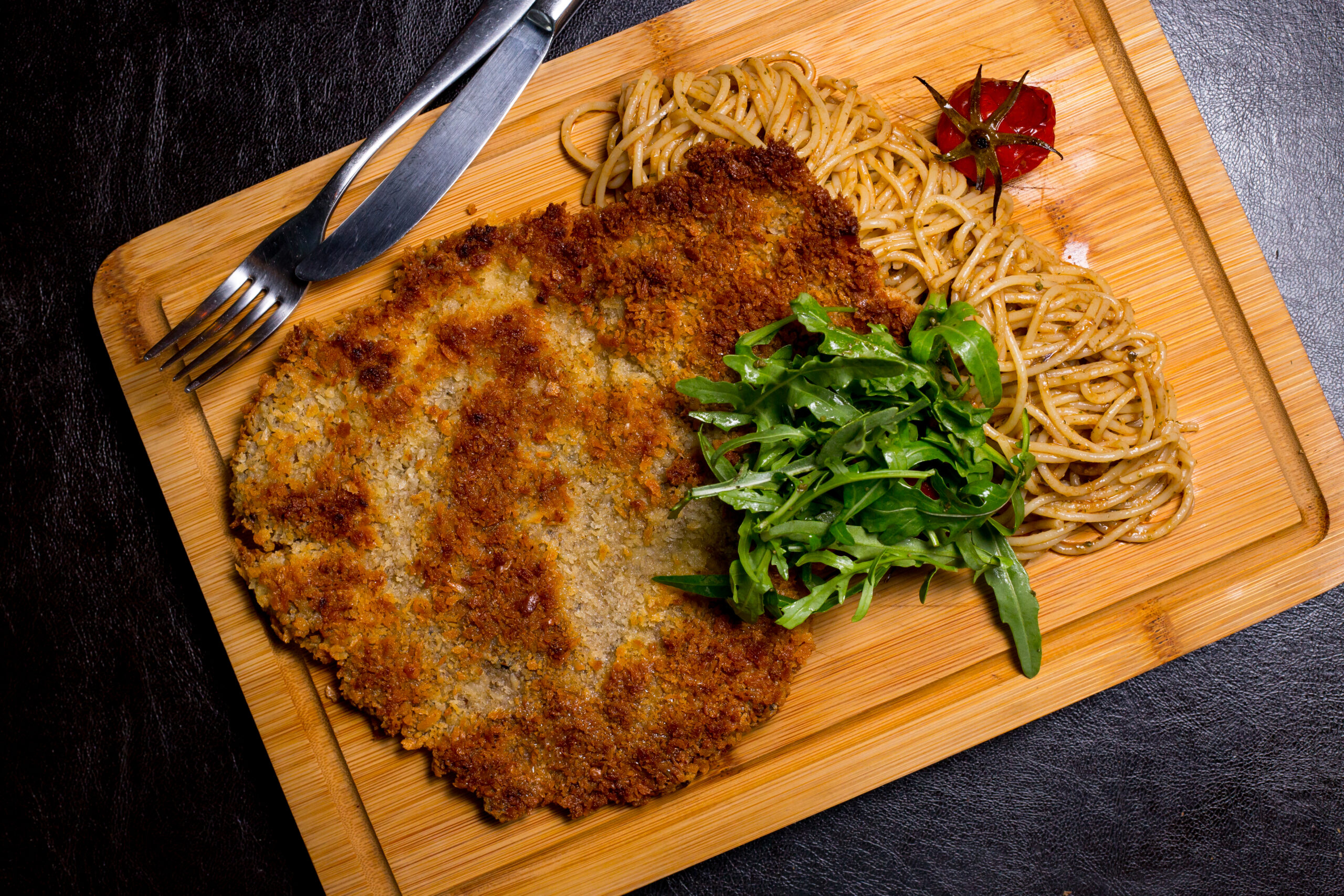veal cutlet on a wooden board