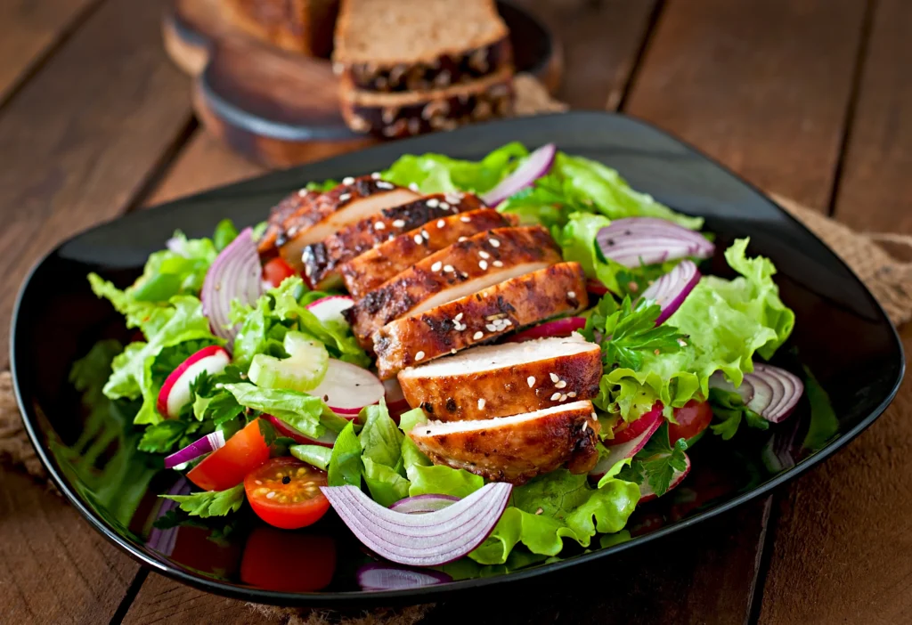 sliced chicken breast with salad