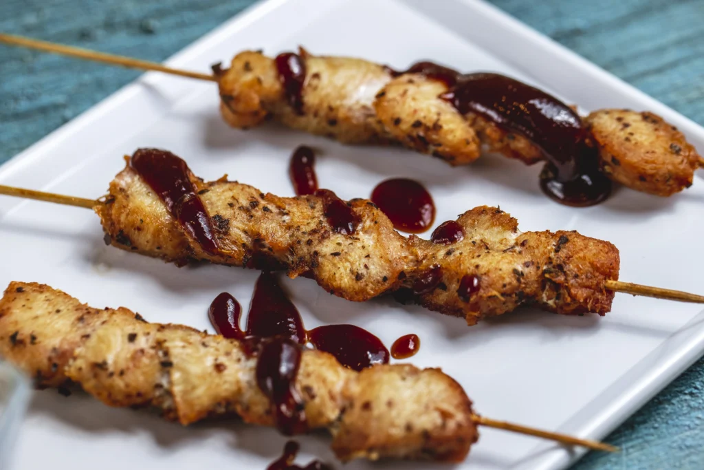 cutlets skewers being served in white plate