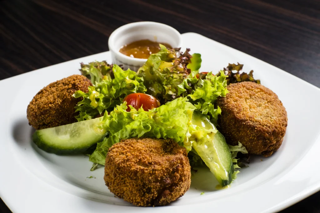 chickpeas cutlets served in whiite plate with salad