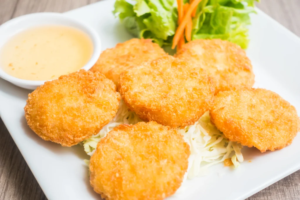 chicken cutlets served in a white plate with sauce