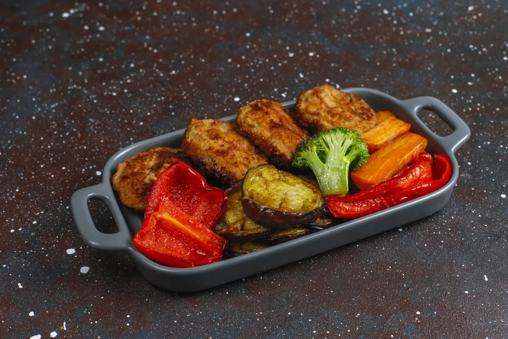 sheet pan chicken cutlets with veges served in pan
