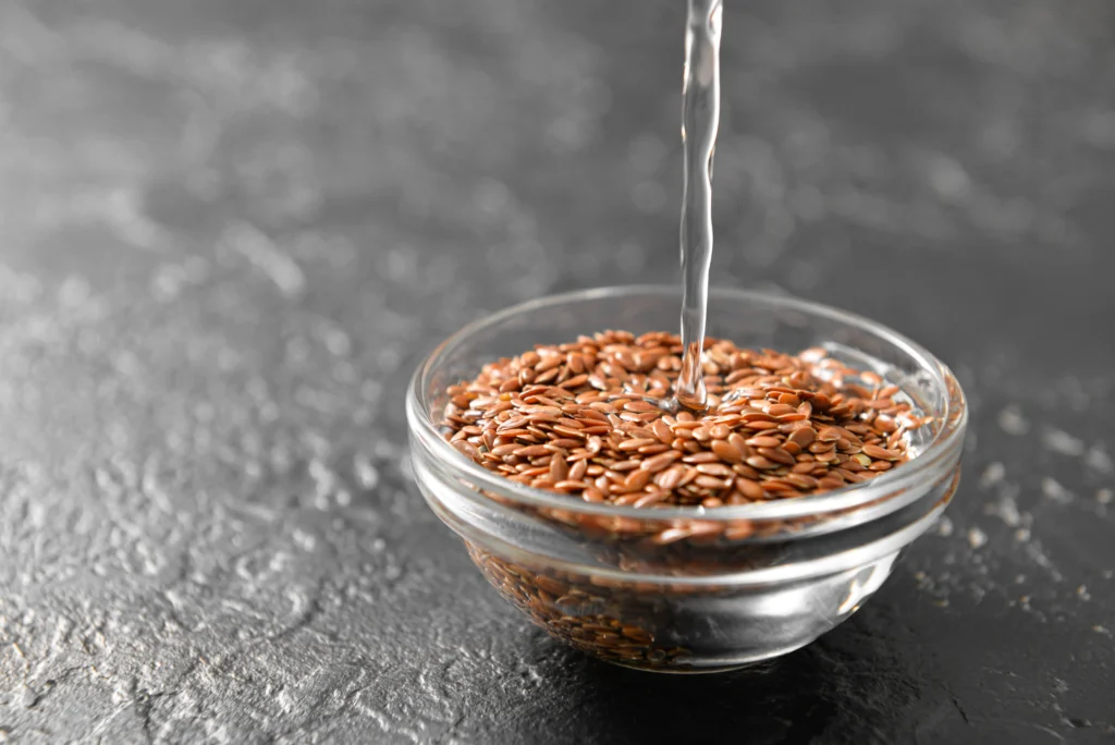 flax seeds being soaked in water in a bowl