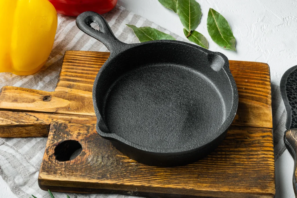 cast iron pan resting on wooden board