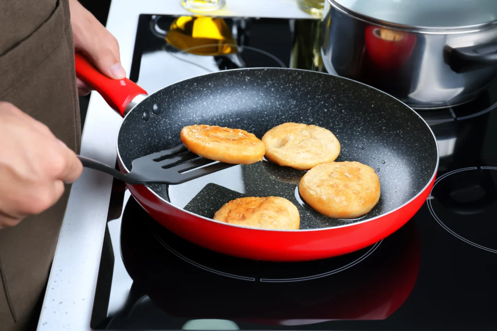 flipping cutlets with silicone tip turner in a red skillet