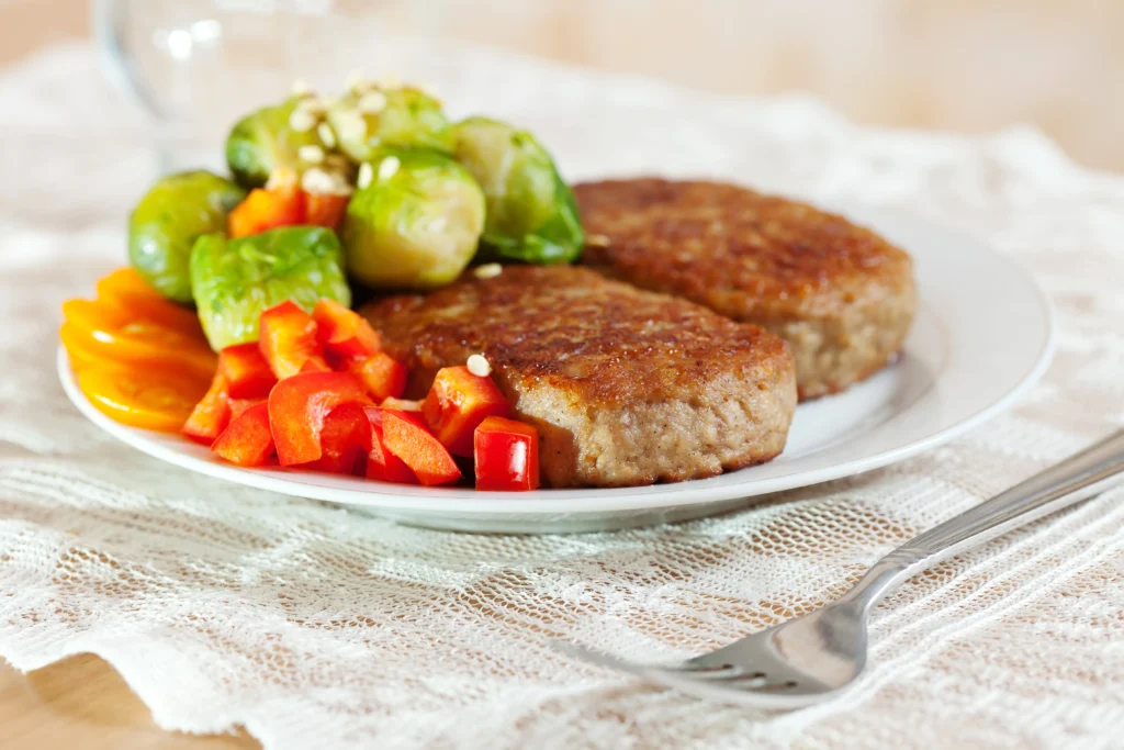 Fried cutlets with colorful vegetables.