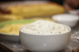 Alabama White Sauce being served in a white bowl