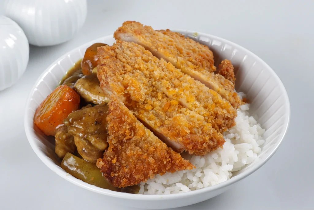 chicken cutlet rice bowl served with sauce