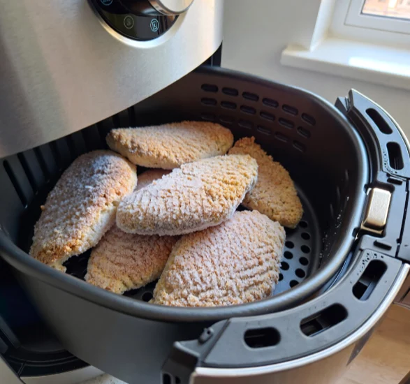 over crowded air fryer with chicken cutlets