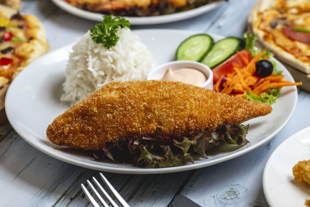 chicken cutlets served with rice and vegetable